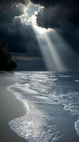 Beach with dramatic clouds and sun rays at dawn photo