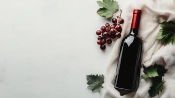 Wine bottle with grapes and leaves on light background, still life. Elegant beverage and fruit concept photo