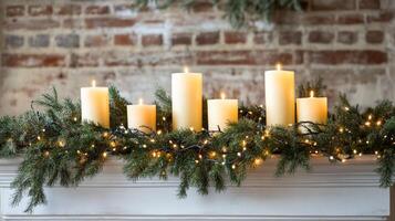 Christmas candles on festive mantel with pine garland and lights, cozy holiday atmosphere photo
