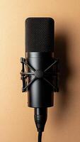 Microphone positioned against a plain backdrop designed for podcasting and audio recording photo