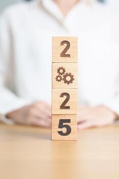 2024 year change to 2025 year block with gear icon. Business Process, Team, teamwork, Goal, Target, Resolution, strategy, plan, Action, motivation, change, brainstorm and New Year start concepts photo