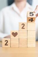 2024 end year to Happy New Year 2025 with heart block for health care, love, organ donation, resolution, charity, happy family, wellbeing and insurance concepts photo