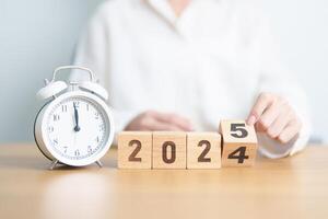 2024 end year to Happy New Year 2025 with vintage alarm clock. Christmas, New Start, Resolution, countdown, Goals, Plan, Action and Motivation Concept photo
