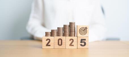 Happy New Year 2025 with Coins stack and dartboard icon. Strategy, goal, Money, Budget, tax, investment, financial, savings and New Year Resolution concepts photo