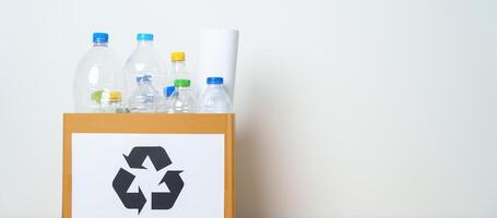 Plastic bottle in paper box at home or office. Recycle garbage Sorting. Plastic Free, Ecology, Environmental, pollution, Dispose recycling, waste management and trash Separation concept photo