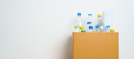 Plastic bottle in paper box at home or office. Recycle garbage Sorting. Plastic Free, Ecology, Environmental, pollution, Dispose recycling, waste management and trash Separation concept photo