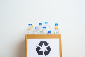 Plastic bottle in paper box at home or office. Recycle garbage Sorting. Plastic Free, Ecology, Environmental, pollution, Dispose recycling, waste management and trash Separation concept photo