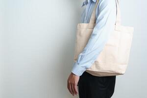 man with Eco Shopping tote bag with Copy space for text. Environmental Protection, Zero waste, Reusable, Say No Plastic, Sustainability, Eco Friendly, World Environment day and Earth day concept photo