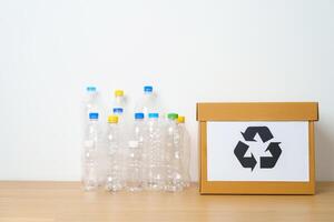 Plastic bottle in paper box at home or office. Recycle garbage Sorting. Plastic Free, Ecology, Environmental, pollution, Dispose recycling, waste management and trash Separation concept photo