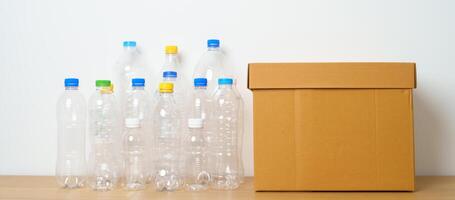 Plastic bottle in paper box at home or office. Recycle garbage Sorting. Plastic Free, Ecology, Environmental, pollution, Dispose recycling, waste management and trash Separation concept photo