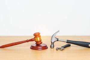Labor law and Worker concepts. Construction hammer with gavel justice hammer on desk in courthouse. photo