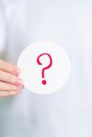 Woman show Questions Mark on paper. FAQ, frequency asked questions, Answer, Q and A, Information, Communication and interrogation Concepts photo