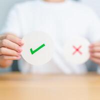 Woman show Right symbol paper. True and false, accept and rejected, evaluation, Vote, Poll, Yes or No and Survey concepts photo