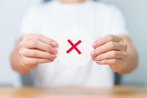 Woman show Wrong symbol paper. True and false, accept and rejected, evaluation, Vote, Poll, Yes or No and Survey concepts photo