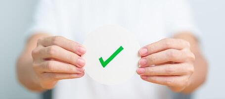 Woman show Right symbol paper. True and false, accept and rejected, evaluation, Vote, Poll, Yes or No and Survey concepts photo