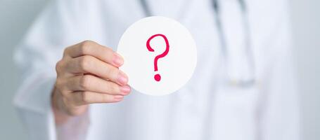 Doctor show Questions Mark on paper. FAQ, frequency asked questions, Answer, Information, Communication, Health, Diagnosis and Medical concept photo