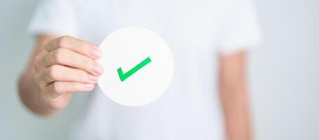 Woman show Right symbol paper. True and false, accept and rejected, evaluation, Vote, Poll, Yes or No and Survey concepts photo