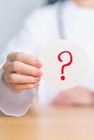 Doctor show Questions Mark on paper. FAQ, frequency asked questions, Answer, Information, Communication, Health, Diagnosis and Medical concept photo