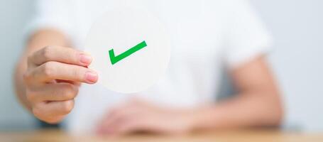 Woman show Right symbol paper. True and false, accept and rejected, evaluation, Vote, Poll, Yes or No and Survey concepts photo