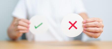 Woman show Wrong symbol paper. True and false, accept and rejected, evaluation, Vote, Poll, Yes or No and Survey concepts photo