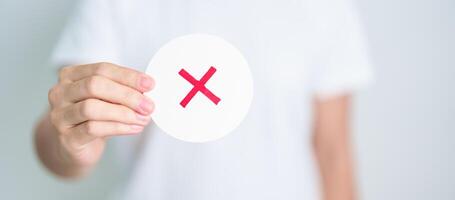 Woman show Wrong symbol paper. True and false, accept and rejected, evaluation, Vote, Poll, Yes or No and Survey concepts photo