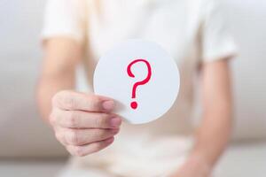 Woman show Questions Mark on paper. FAQ, frequency asked questions, Answer, Q and A, Information, Communication and interrogation Concepts photo