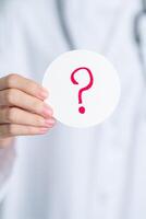 Doctor show Questions Mark on paper. FAQ, frequency asked questions, Answer, Information, Communication, Health, Diagnosis and Medical concept photo