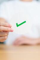 Woman show Right symbol paper. True and false, accept and rejected, evaluation, Vote, Poll, Yes or No and Survey concepts photo