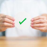 Woman show Right symbol paper. True and false, accept and rejected, evaluation, Vote, Poll, Yes or No and Survey concepts photo