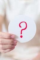Woman show Questions Mark on paper. FAQ, frequency asked questions, Answer, Q and A, Information, Communication and interrogation Concepts photo