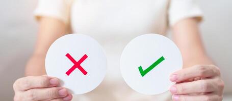 Woman show Wrong and Right symbol paper. True and false, accept and rejected, evaluation, Vote, Poll, Yes or No and Survey concepts photo