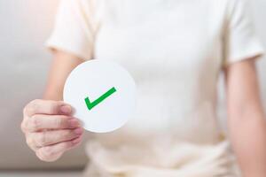 Woman show Right symbol paper. True and false, accept and rejected, evaluation, Vote, Poll, Yes or No and Survey concepts photo