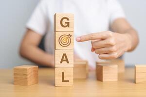GOAL block with dartboard sign. Business Goal, Target, Objective, strategy, plan, Action motivation, mission and process concepts photo