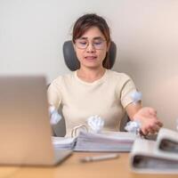 stressed Asian Woman using laptop with mistake paper, Tired female businesswoman working overload at office, Exhausted casual woman with computer at late night in home. Failure, Problem and business photo