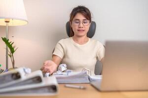 stressed Asian Woman using laptop with mistake paper, Tired female businesswoman working overload at office, Exhausted casual woman with computer at late night in home. Failure, Problem and business photo