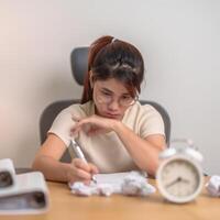 stressed Woman with mistake paper and clock, Tired female businesswoman working overload at office, Exhausted woman with document folder stack at late night in home. Failure, Problem and business photo