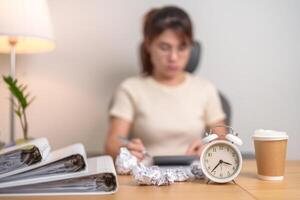 stressed Woman with mistake paper and clock, Tired female businesswoman working overload at office, Exhausted woman with document folder stack at late night in home. Failure, Problem and business photo
