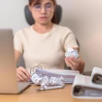 stressed Asian Woman using laptop with mistake paper, Tired female businesswoman working overload at office, Exhausted casual woman with computer at late night in home. Failure, Problem and business photo