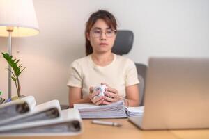 stressed Asian Woman using laptop with mistake paper, Tired female businesswoman working overload at office, Exhausted casual woman with computer at late night in home. Failure, Problem and business photo