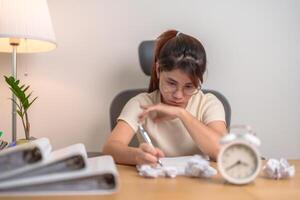 stressed Woman with mistake paper and clock, Tired female businesswoman working overload at office, Exhausted woman with document folder stack at late night in home. Failure, Problem and business photo