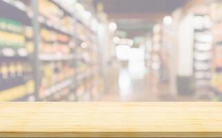 Empty wood table top with supermarket blurred background for product display photo