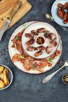 Italian bacon wrapped dates appetizer. photo