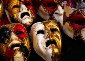 exhibition of colorful Venetian masks with a sad and dejected expression. photo