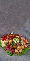 Enjoy a Delicious Assorted Platter Filled with Tasty Meats and Variety of Snacks photo