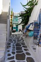 Whitewashed alley with stairs and colorful doors and windows in Mykonos, Greece. Traditional Cycladic architecture. photo