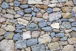 The surface of an old stone wall, perfect for the background. photo