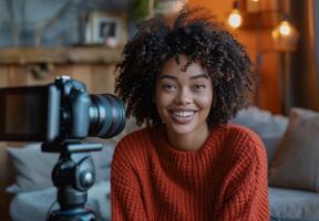 Woman vlogger. Social blog of young girl. Media online african american influencer. Cheerful friendly attractive female portrait in room photo