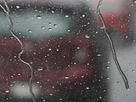 heavy rain slow motion on car window while driving photo