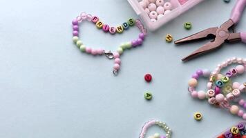 Crafting colorful bracelets with beads and tools on a table video