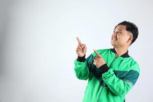 Asian Online Driver with Unifrom Jacket Pointing at Copy Space photo